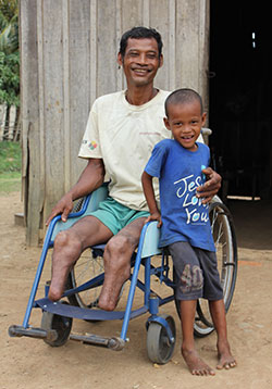 車いすを受け取ったカンボジアのソイさん父子