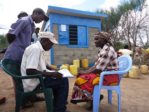 水販売所の前でインタビューに応える女性