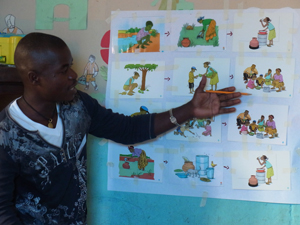 感染症の感染ルートを示すイラストを指し示す先生