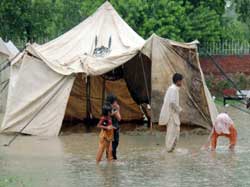 被災者のテントをなお襲う洪水
